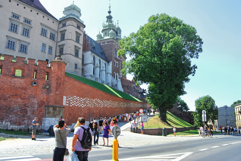 8 - The historic Wawel Royal Castle and Wawel Cathedral rising above the red brick fortifications on Wawel Hill in Kraków, Poland